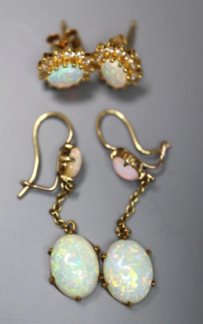 A pair of yellow metal and two stone oval white opal drop earrings, 32mm, gross 2.5 grams, and a pair of 750 and opal ear studs